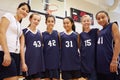 Members Of Female High School Basketball Team With Coach