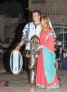 Members of the Knights of Jerusalem club dressed in traditional armor of a knight and a dress of ladies posing in front of photogr