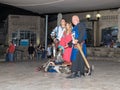 Members of the Knights of Jerusalem club dressed in the traditional armor of a knight, are fighting on swords at night in the old