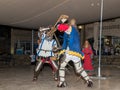 Members of the Knights of Jerusalem club dressed in the traditional armor of a knight, are fighting on swords at night in the old