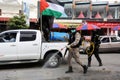 Members of the Palestinian Islamic Jihad`s armed wing, the Al-Quds Brigades, spray disinfectant in the streets of Rafah in the sou