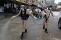 Members of the Palestinian Islamic Jihad`s armed wing, the Al-Quds Brigades, spray disinfectant in the streets of Rafah in the sou