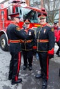 Members of the Quebec City fire brigade in dress uniform standing next to a fire truck before the St. Patrick parade i