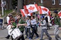 members of Scouts Canada holding Canadian flags march along Queen Street East in the Beaches Easter Parade 2017