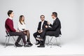 Members Of Support Group Sitting In Chairs Having Meeting on white background Royalty Free Stock Photo