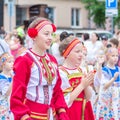 Members of theater groups in national costumes at the festive procession of graduates of schools