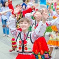 Members of theater groups in national costumes at the festive procession of graduates of schools