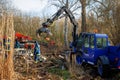 Members of THW remove construction debris with the help of a wheeled excavator