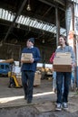 Members and volunteers from BookCycle UK carry boxes of books