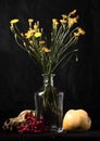 Memento Mori. Still life of a skull, viburnum, a glass bottle with a bouquet and an old newspaper