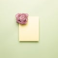 Memo pad with dry flower on light green background Royalty Free Stock Photo