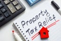 Memo about Property tax relief in the notebook. Royalty Free Stock Photo