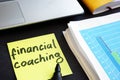 Memo stick with words financial coaching. Education.