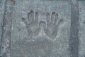 Memorable handprint of a hands in an old concrete wall