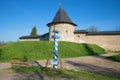 A memorable milestone against the background of an ancient defensive tower of Pskov-Caves Monastery, Russia Royalty Free Stock Photo