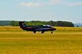 Memorial Airshow. Czech L29 advanced jet traning aircraft. Landing at a grassy airport.