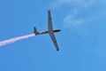 Memorial Airshow. Flying Glider aerobatic team withlight sailplane showing his performance, smoke effect