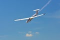 Memorial Airshow. Flying Glider aerobatic team withlight sailplane showing his performance, smoke effect