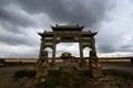 The memorial arch under the dark clouds