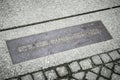 Memorial board of Berlin wall on pavement, germany