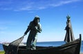 bronze statues of fishermen and Our Lady