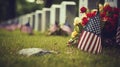 A grave with an american flag and colorful flowers are noticeable in the background for memorial day