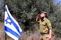 Memorial Day for Israel. Soldier salutes the Israeli flag