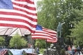 Memorial day, Monday, May 29, 2023, Lexington, MA. Tourists Visiting Battle Green, Minuteman Statue, US Flags Waving in Breeze