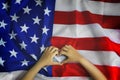 Memorial Day or 4th of July. Child`s hands are folded in the shape of a heart on American flag. Veterans Day. Greeting card or