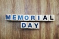 Memorial day word created with cubes alphabet letters on wooden background Royalty Free Stock Photo