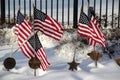 Memorial flags and grave markers in snow