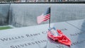 Memorial at Ground Zero Manhattan for September 11 Terrorist Attack with an American Flag Standing near the Names of Victims