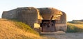 Gun emplacement at Omaha Beach. Bomb shelter with german long-range artillery gun from world war 2 in Longues-sur-Mer in Normandy. Royalty Free Stock Photo