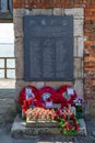 The memorial to the Falklands war dead at The Hotwalls in old Portsmouth with poppy wreaths laid in front of it