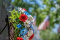 Memorial wreath laid in front of veterans memorial in park on sunny Memorial Day Royalty Free Stock Photo