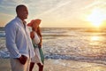 Memories made together last a lifetime. a young couple taking a romantic stroll on the beach at sunset.