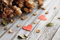 Memories of romantic love. Two red hearts and dried bouquet of roses on gray wood Royalty Free Stock Photo
