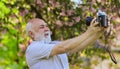 Memories in snap. Everyone photogenic. Senior man taking selfie photo vintage camera. Retro equipment for taking photo Royalty Free Stock Photo