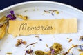 Memories word and letter on the old paper, autumn dried flowers