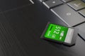 High capacity memory card on laptop close-up. SDXC 512 gb. Modern storage devices concept. Top angle view. Keyboard