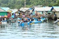 Men on anchored boat by fishermen village in Manokwari Royalty Free Stock Photo