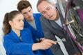 men and apprentice working at bike store Royalty Free Stock Photo