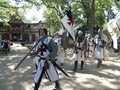 Men in armor, bearing crusade flags, walking down the streets at Bristol Renaissance Faire