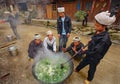 Men Asians, Chinese peasants, farmers, cook on rural street vil