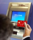 Men at ATM machine doing banking transaction Royalty Free Stock Photo