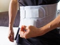 Men with back pain support belt or medical belt, orthopedic lumbar support
