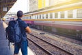 Men backpacker waiting for his train in railway station .