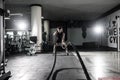 Strong Men with battle rope battle ropes exercise in the fitness gym. CrossFit. Royalty Free Stock Photo