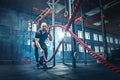 Men with battle rope battle ropes exercise in the fitness gym. Royalty Free Stock Photo