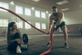 Men with battle rope battle ropes exercise in the fitness gym. Royalty Free Stock Photo